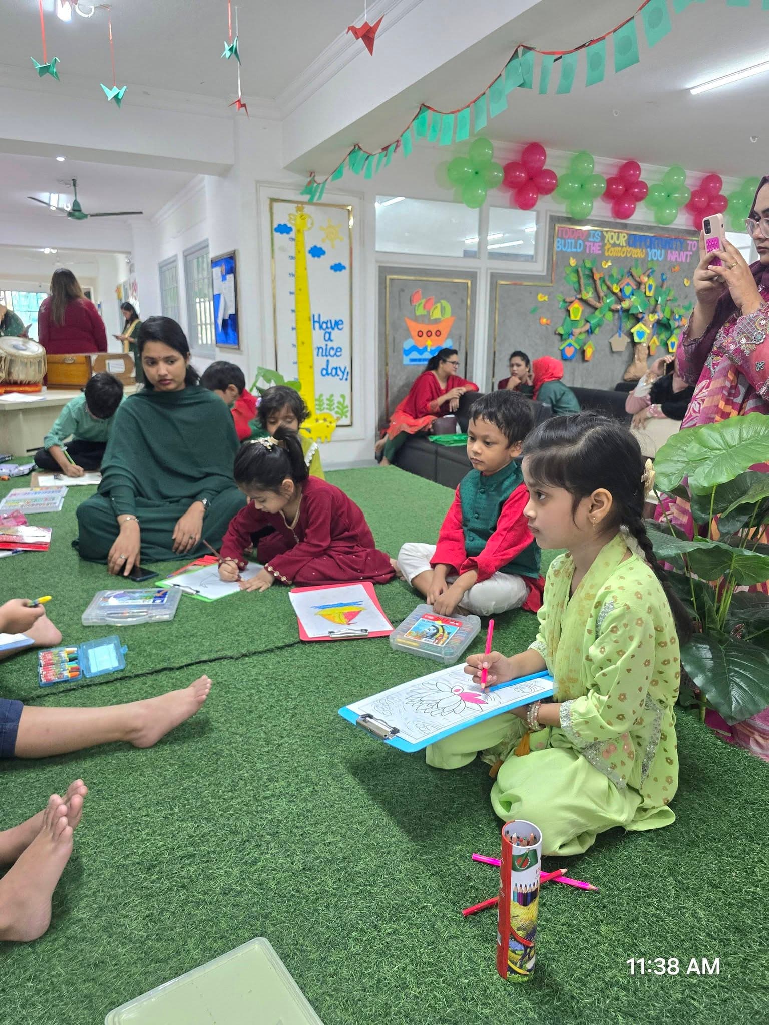 Students seated drawing and colouring during a cultural event